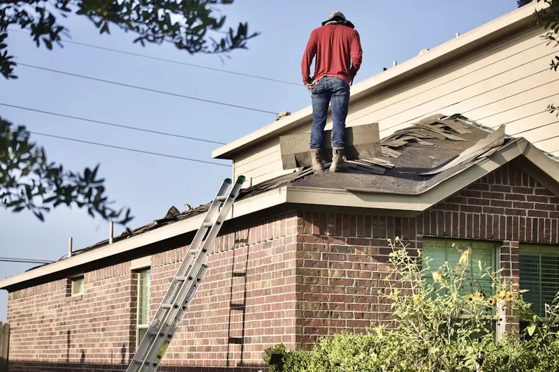 Professional roofer working on a residential roof in Eaton